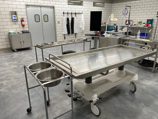 An affordable stainless steel embalming table with built-in features.